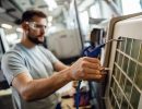 Close up of worker operating an industrial machine in a factory.