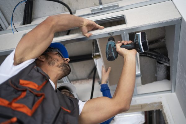 low-angle-people-working-with-drill (1)